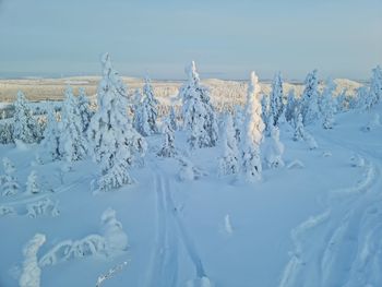 Snow covered land against sky