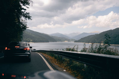 Road by mountain against sky