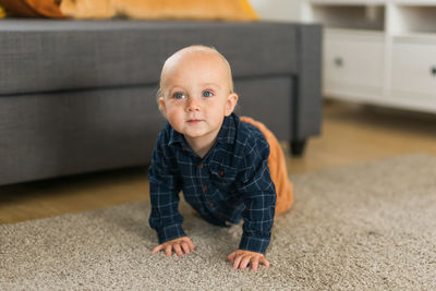 Portrait of boy standing on floor