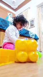 Girl sitting with toy at home