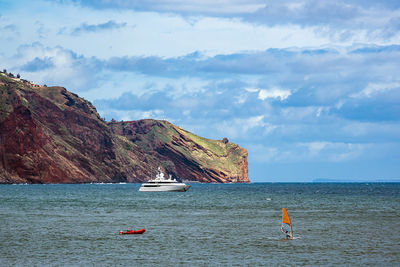 Sailboat on sea against sky