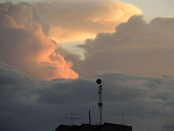 Silhouette building against sky during sunset