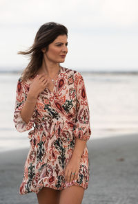 Young woman standing at beach