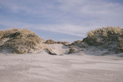 Scenic view of arid landscape against sky