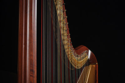 Close-up of harp against black background