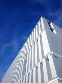 Low angle view of office building against blue sky