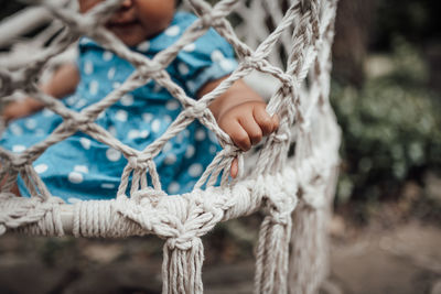 Close-up of human hand holding rope