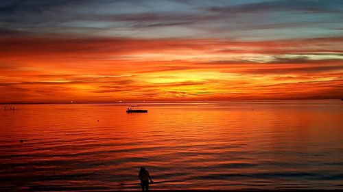 Scenic view of sea against orange sky