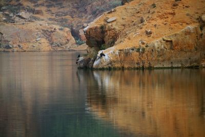 Reflection of rock on water in lake