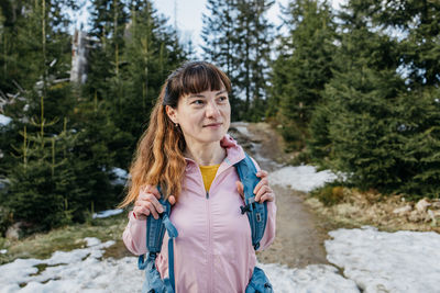 Portrait of a young girl walking in the forest. the girl is engaged in hiking, resting and relaxing