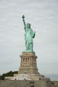 Low angle view of statue against cloudy sky