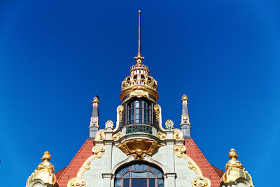 Low angle view of traditional building against blue sky