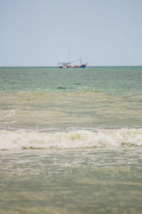 Sailboat in sea against clear sky