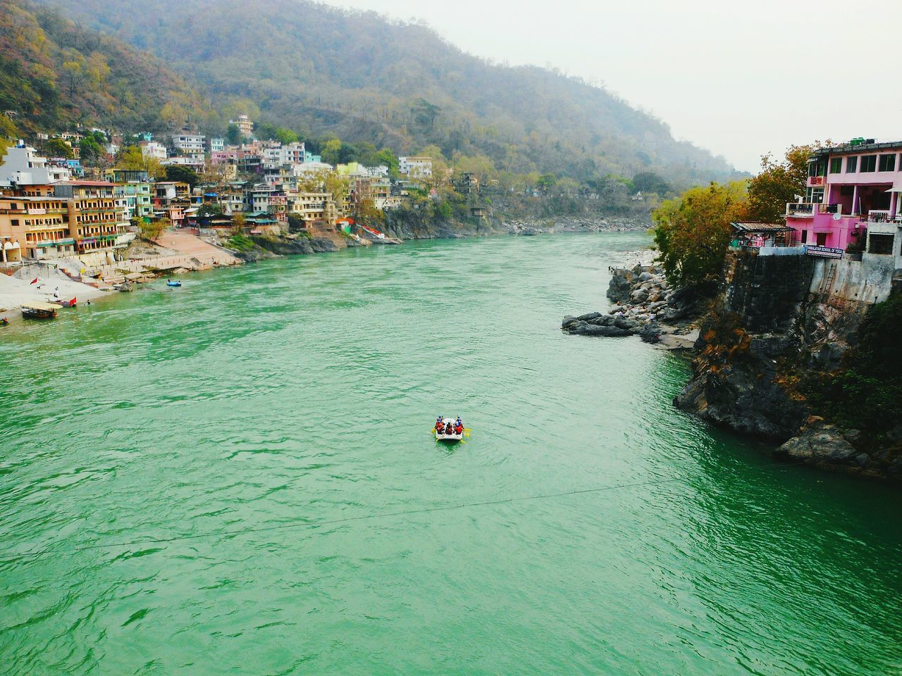 water, waterfront, building exterior, architecture, built structure, nautical vessel, transportation, mountain, river, boat, mode of transport, tree, high angle view, house, nature, hill, scenics, rippled, tranquility, incidental people