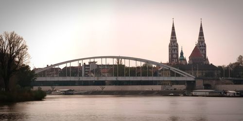 Bridge over river with buildings in background