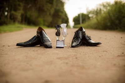Wedding rings with shoes and wineglasses on land
