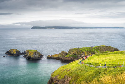 People on footpath to carrick a rede rope bridge, northern ireland
