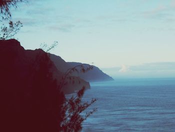 Scenic view of sea and mountains against sky