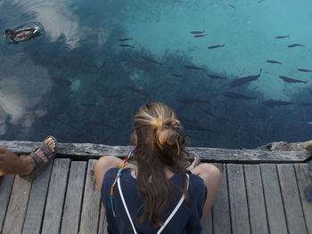 Rear view of two people looking at water