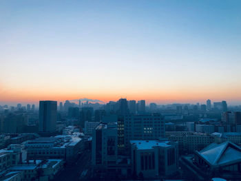 High angle view of buildings against sky during sunset