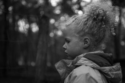 Close-up of boy against trees