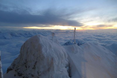 Scenic view of snow mountains against sky during sunset