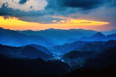 Scenic view of mountains against sky at sunset