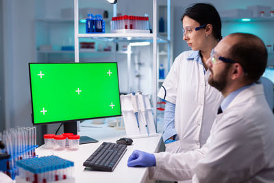 Scientist looking at computer monitor at laboratory