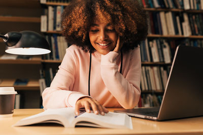 Young woman using laptop at table