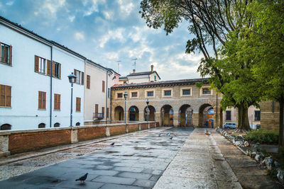 Street amidst buildings in city against sky