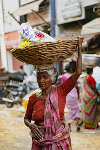 Midsection of woman wearing mask for sale at market