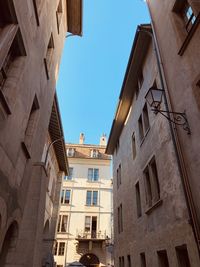 Low angle view of buildings against clear blue sky