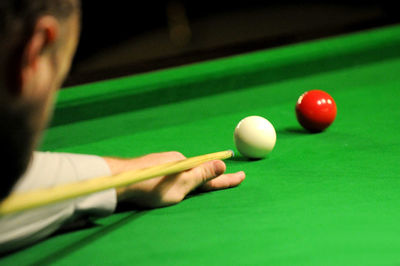 Close-up of man playing pool