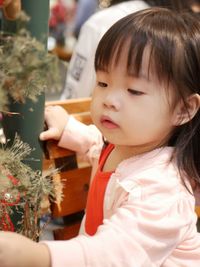 Cute girl looking at christmas tree