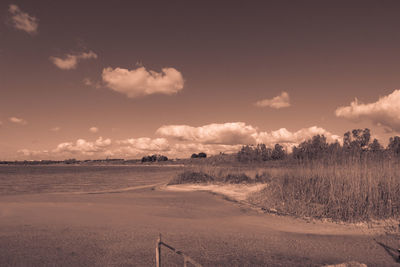 Scenic view of road by land against sky