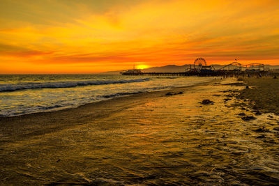 Scenic view of sea against romantic sky at sunset