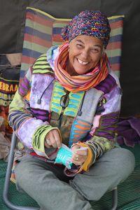 Portrait of a smiling girl sitting outdoors