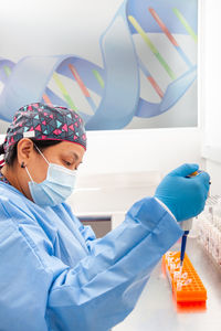 Female scientist extracting dna using the spin column-based nucleic acid purification technique