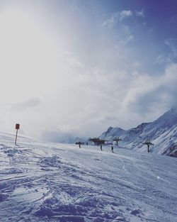 Scenic view of snow covered field against sky