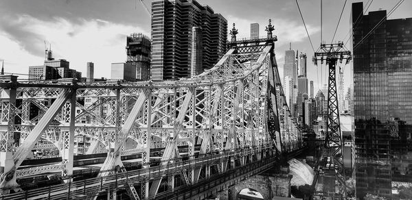 Panoramic view of bridge and buildings against sky