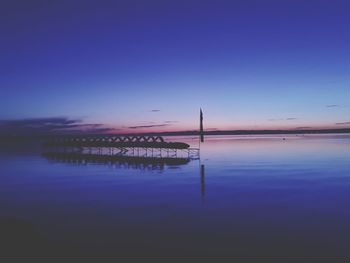 Scenic view of lake against sky at sunset