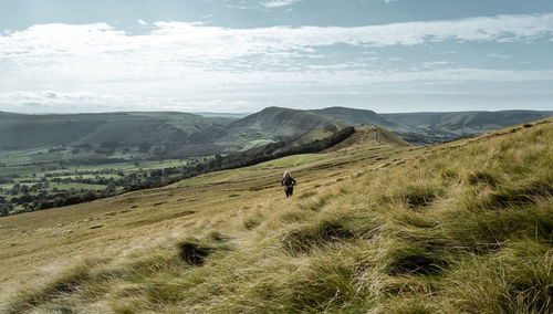 Rear view of man on landscape against sky