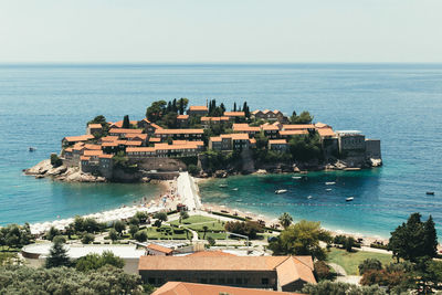 High angle view of buildings by sea