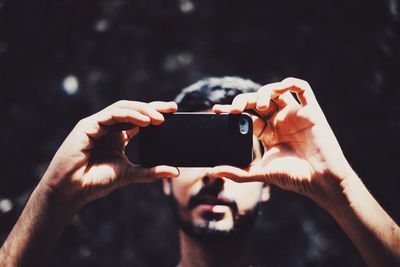 Midsection of man using mobile phone