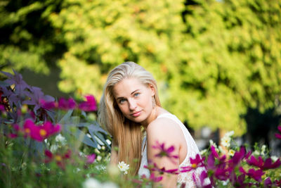 Close-up of smiling young woman with flowers