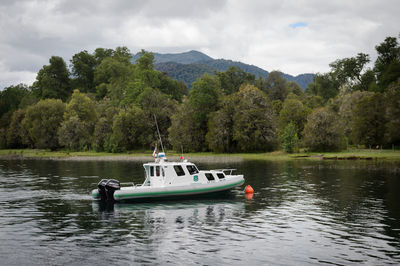 Boat in lake against sky