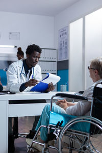 Doctor examining patient in clinic