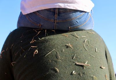 Rear view of man standing against clear blue sky