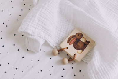 Single wooden toy on a white textured background