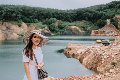 Portrait of young woman standing in water